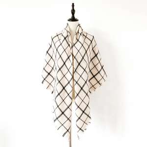 Detail of classic black and white checkered scarf with fringe on a white mannequin