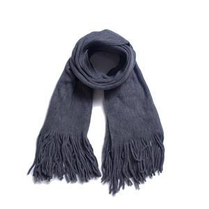 Detailed view of dark grey winter scarf featuring long tassels and soft knit texture