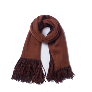 Close-up of thick brown knit scarf showing ribbed texture and long tassel details
