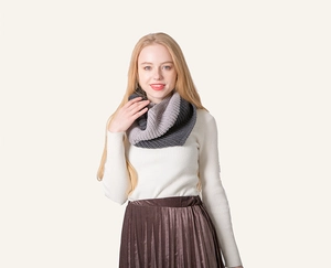 Detail of grey gradient knitted snood scarf featuring thick chunky textured yarn