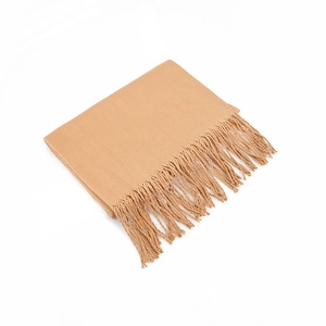 Detailed view of camel solid cashmere-feel scarf with fine twill weave and fringe edges
