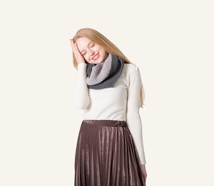 Detail of gray two-tone knitted snood showing thick knit texture and soft winter material