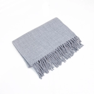 Close-up of light gray cashmere-feel scarf texture featuring fine fringe and soft weave