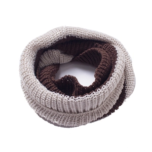 Detailed view of the chunky knit pattern on a beige and brown striped infinity scarf