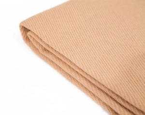 Detail of camel cashmere-like scarf showing luxury twill weave texture and fabric softness