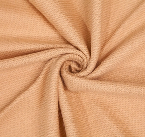 Macro texture of camel cashmere scarf showing soft weave and thick knit details
