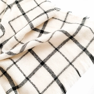 Classic black and white plaid scarf with fringe edges in soft cashmere-like fabric