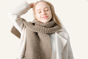 Close-up of thick chunky knit scarf in khaki showing warm texture and weave detail