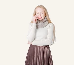 Close-up of coffee and grey mixed knit texture on warm winter snood scarf for adults