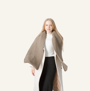 Close-up of thick knitted winter scarf texture in dark coffee brown wool blend fabric