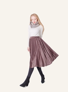 Detail of mauve velvet pleated midi skirt paired with grey scarf and white sweater