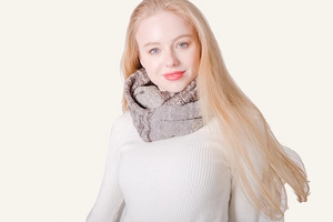 Close-up of thick chunky knit infinity scarf in mixed brown and beige yarn on model