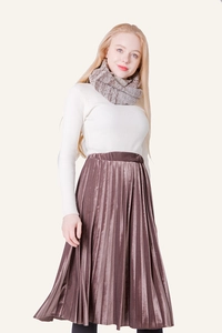 Detail shot of a brown knitted scarf paired with a white rib-knit sweater and pleated skirt