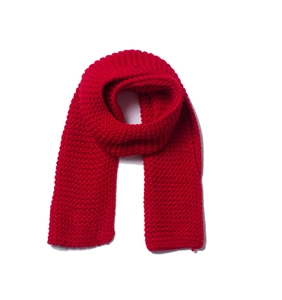 Detailed view of the thick knit texture and vibrant red yarn of this winter scarf