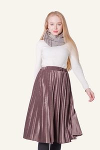Winter outfit detail with white knit sweater, velvet pleated skirt and knitted scarf