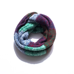 Detailed texture of thick knit colorful striped infinity scarf with patchwork patterns