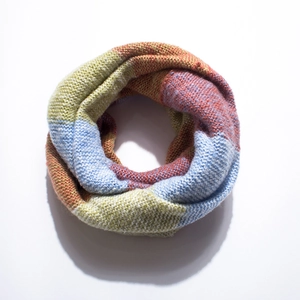 Close-up of chunky knit neck warmer featuring vibrant color block patterns and texture