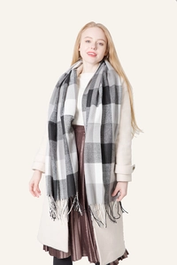 Detail of British style black and grey plaid scarf with handmade tassel ends
