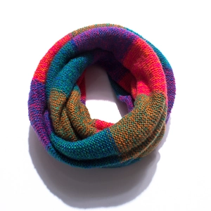 Detailed close-up of colorful mixed knit infinity scarf with soft textured yarn patterns