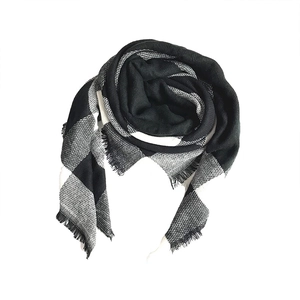 Detail of classic black and white buffalo check scarf showing soft cashmere-like texture