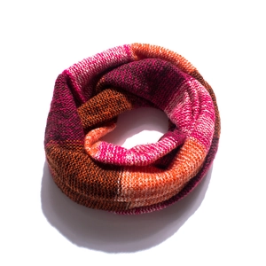 Detail of colorful knitted infinity scarf showing pink and orange block textures