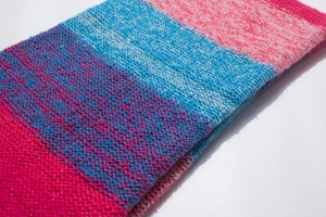 Detailed macro view of the colorful striped thick knit scarf texture and stitch pattern