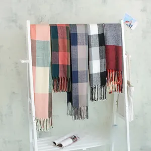 Classic British plaid scarves with tassels in multiple colors on a minimalist display