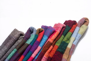 Detailed view of thick multi-color striped knitted scarves with vibrant ethnic textures
