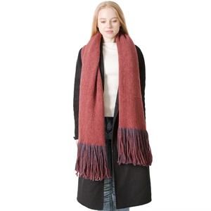 Thick rust red winter scarf with deep purple fringe tassels on solid white background