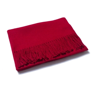 Detail of red wool scarf featuring dense knit texture and neat fringe tassel edges