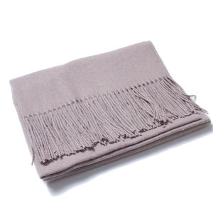 Detail view of light brown wool scarf showing fine knit texture and long tassel edges