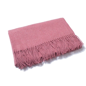 Detail shot of dusty rose wool scarf showing soft knit texture and long fringe tassels