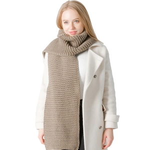 Winter thick chunky knit scarf in solid brown paired with a classic white wool coat