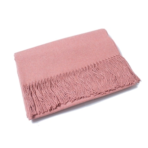 Close-up of solid rose pink wool scarf featuring fine knit texture and fringe tassels