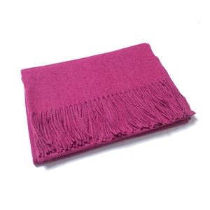 Detailed close-up of dark pink wool scarf featuring high-quality twisted fringe tassels