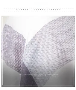 Close-up of soft plaid cashmere-like fabric showing a grey-purple and white herringbone texture