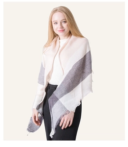 Detail of color-block scarf featuring soft fringe edges in white, beige, and dark grey
