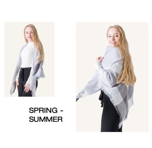 Detail of gray and white checkered shawl scarf with soft cashmere-like texture and fringes