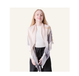 Detail of soft cashmere-like pink and grey plaid shawl with delicate fringe edges