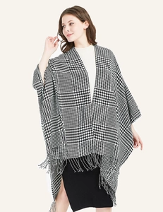 Detail of classic black and white houndstooth shawl with elegant fringe and soft texture