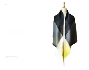 Close-up of geometric color-block scarf with heavy cashmere feel and fringe details