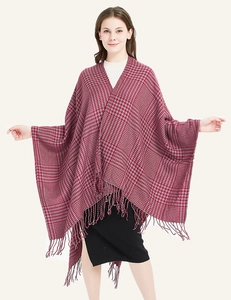 Close-up of red and grey houndstooth knit texture with delicate fringe tassels