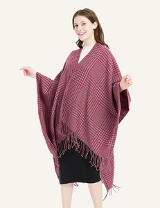 Close-up of red and grey houndstooth shawl detailing soft texture and fringe hem