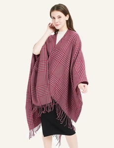 Detail of red and grey houndstooth shawl with tassel fringe on a female model