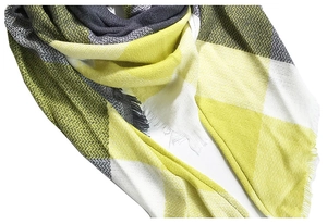 Close-up of yellow and grey plaid scarf fabric texture with soft fringe details