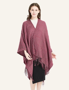 Close-up of red and grey houndstooth knit shawl with fine fringe details and soft texture
