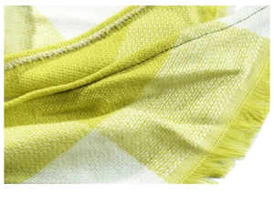 Close-up of yellow and white plaid scarf fabric with thick texture and fringe edge