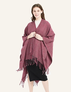 Detailed close-up of red and grey houndstooth shawl with elegant fringe tassels