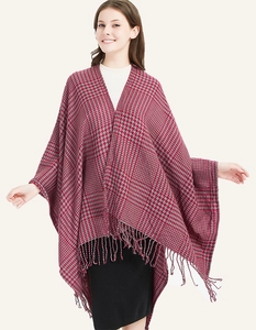 Close-up of red and grey houndstooth knit texture and handmade tassel details on shawl