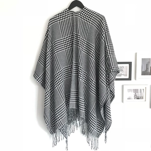 Classic black and white houndstooth poncho shawl with tassel fringe and open front design